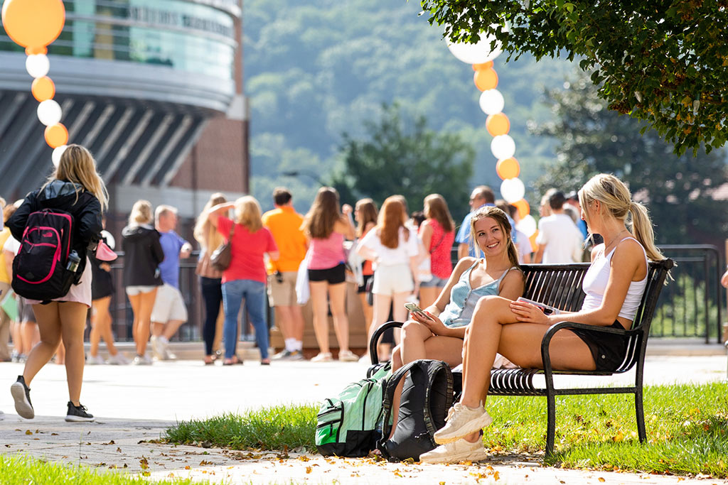 Students sitting on a bench on the first day of classes
