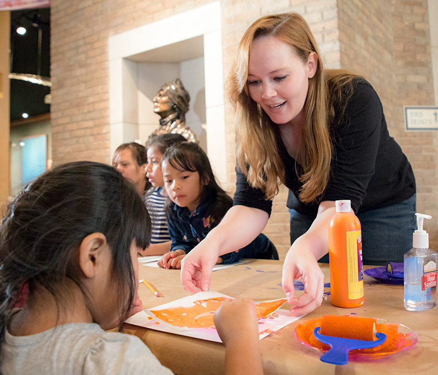 A student volunteer leads a child activity at McClung Museum