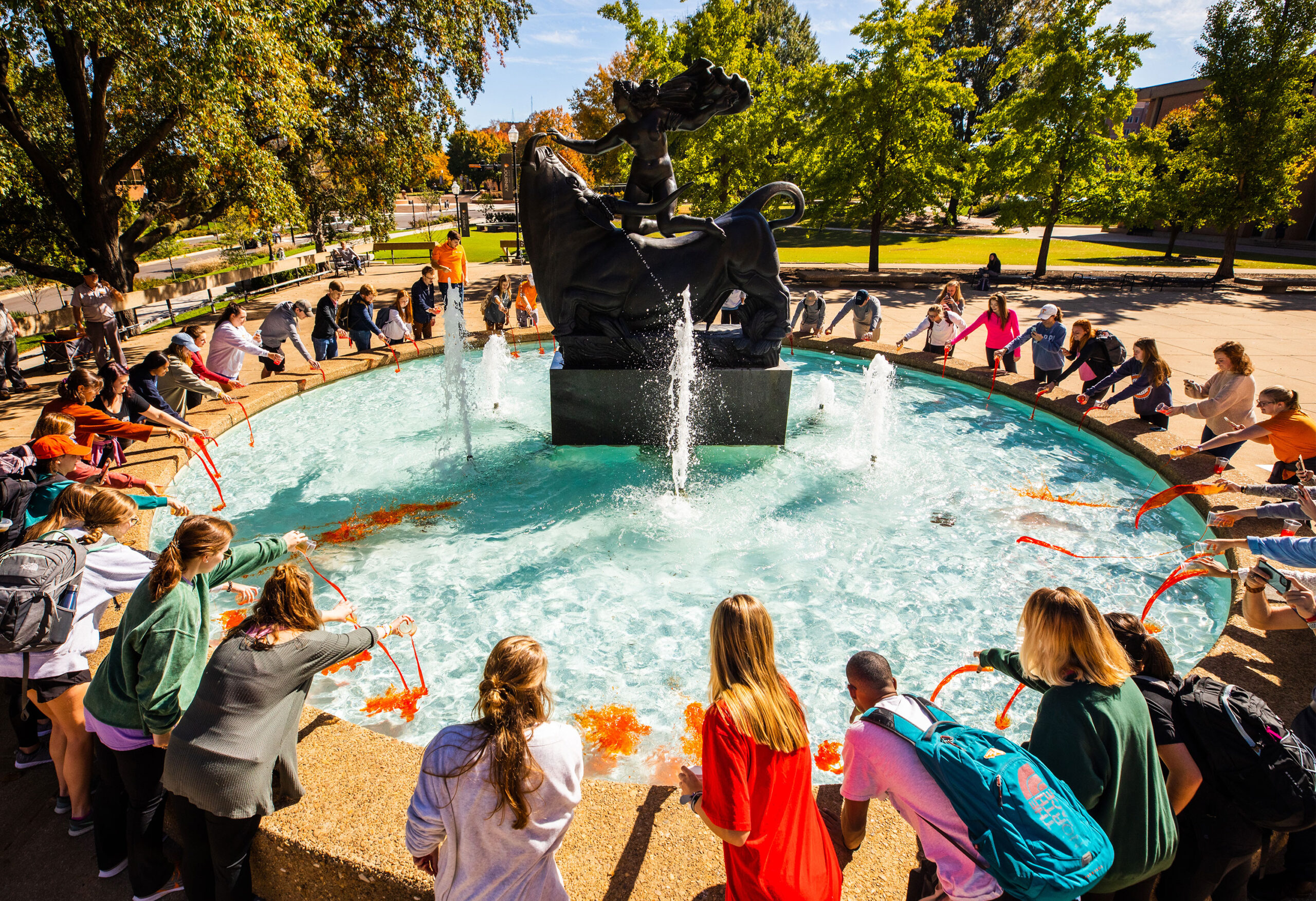 Students gather to color the water of the fountain orange—a longtime game day tradition