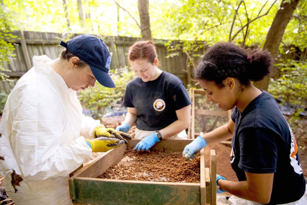 Law enforcement officers work on a burial excavation at the Anthropology Research Facility (also known as the Body Farm)