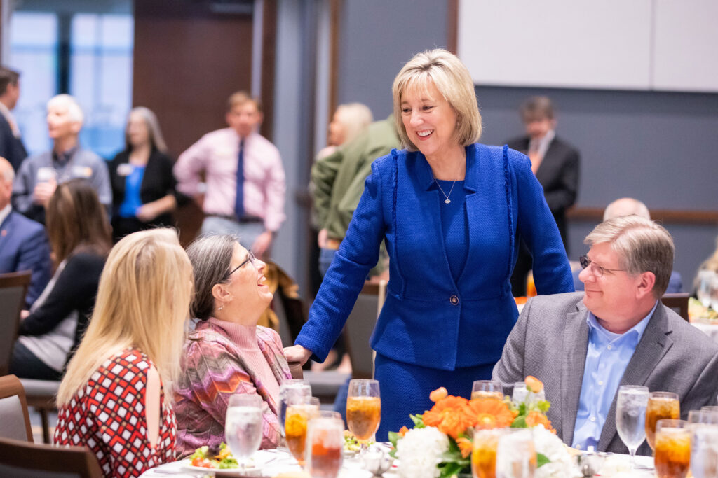 chancellor Donde Plowman mingles with faculty at an evening event