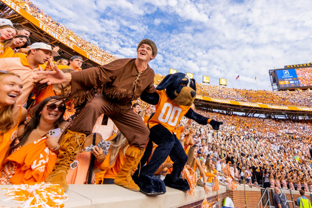 The Volunteer and Smokey stand on the wall at Neyland Stadium during a packed checkers game