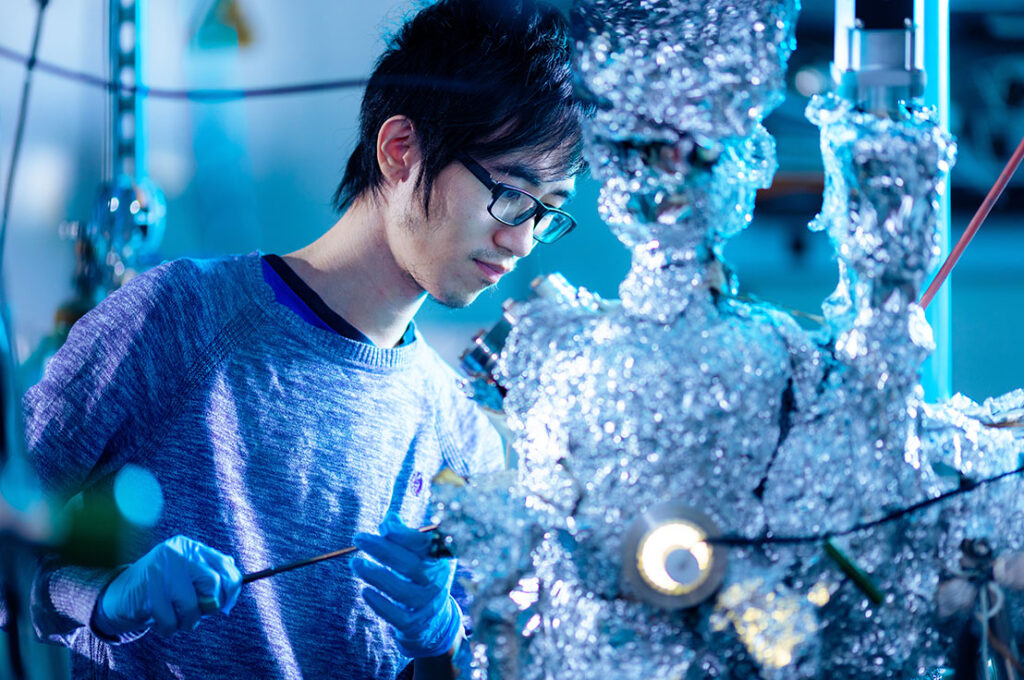 A graduate student works in the Molecular Beam Epitaxy Core Facility for a research