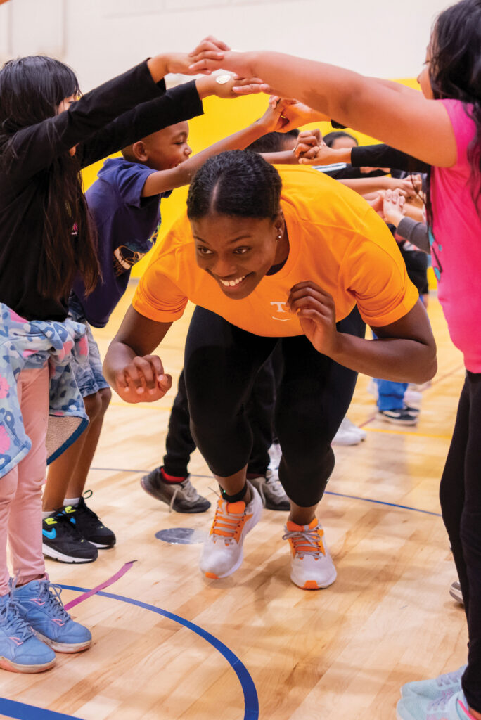 Morgahn Fingall interacts with young children who are happy and engaged in group play