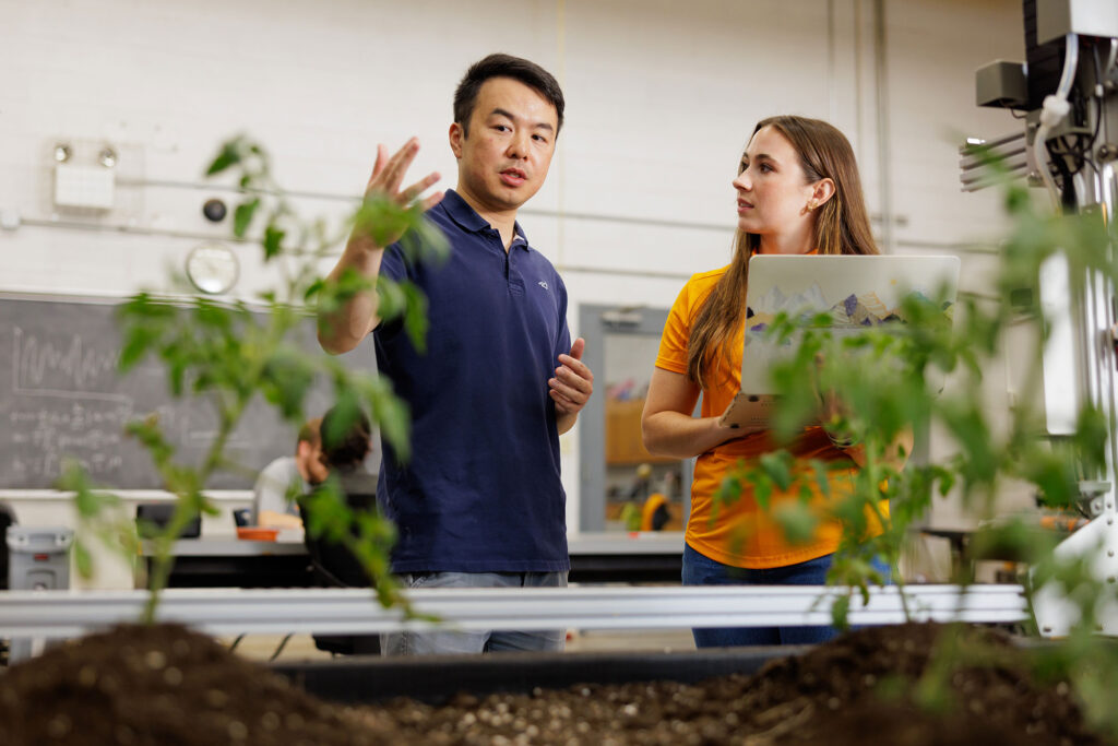 Professor and student works with a farm bot in the Smart Agriculture Lab in the Biosystems Engineering and Soil Science building