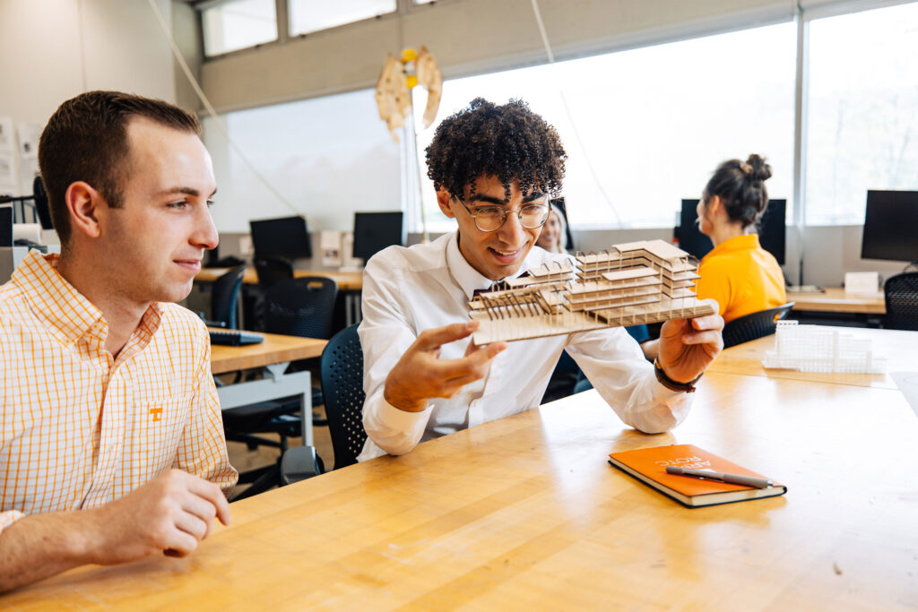 A student holds an architectural model