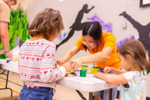 a student works with young children