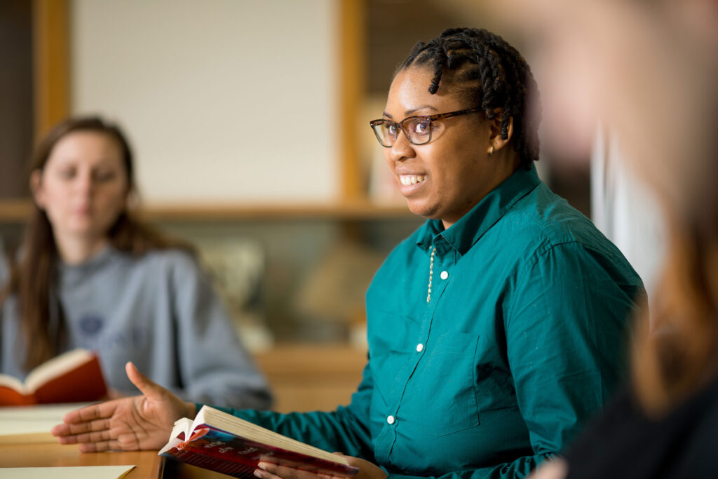 A woman leads a class discussion