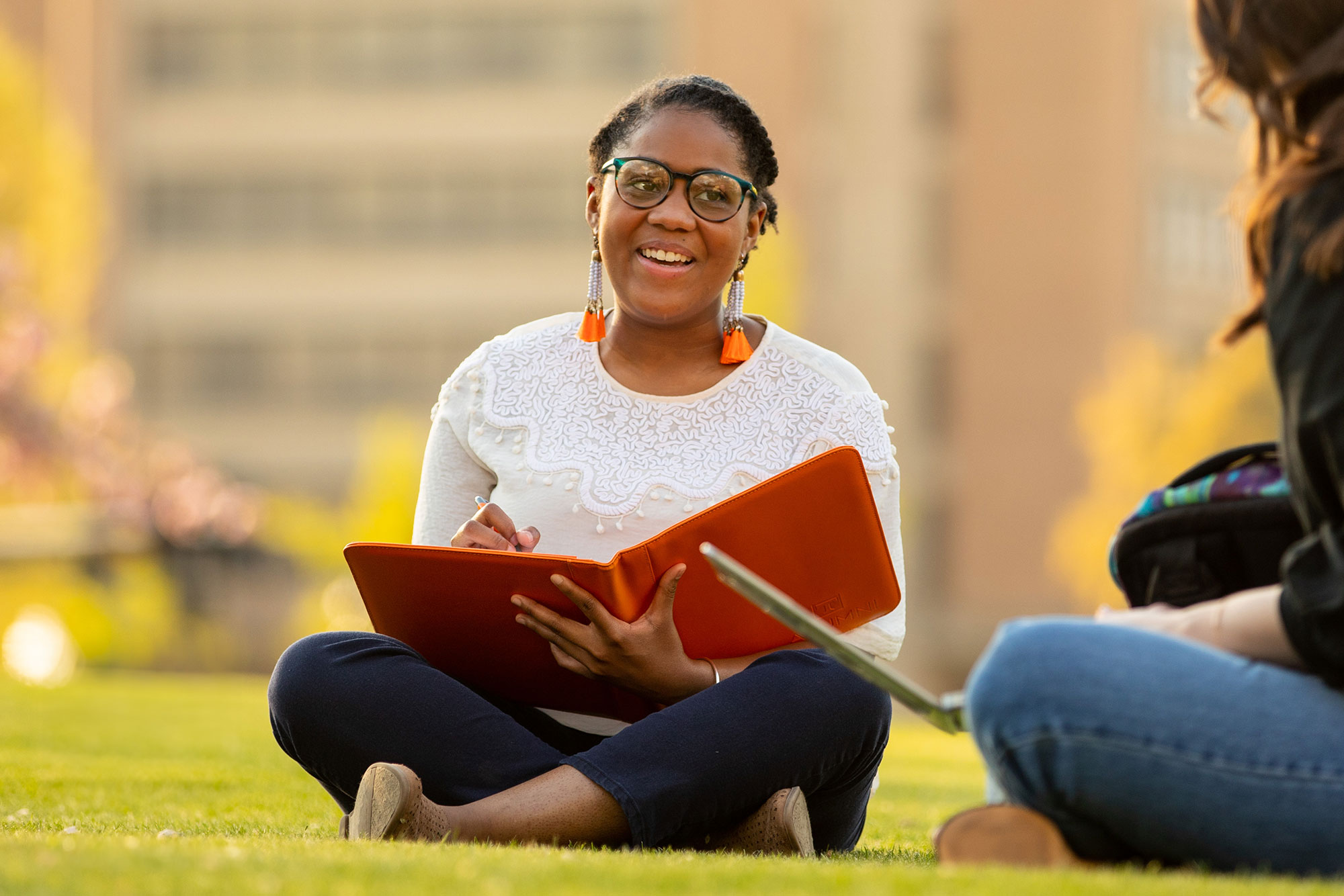 students sit outside studying