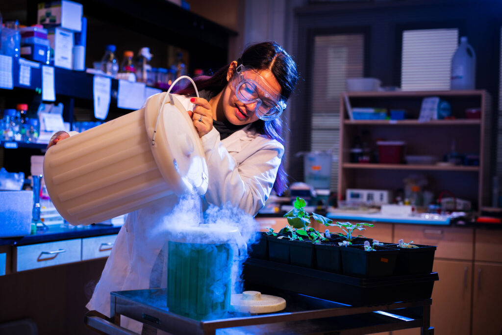 student working in a biology lab works with vapors