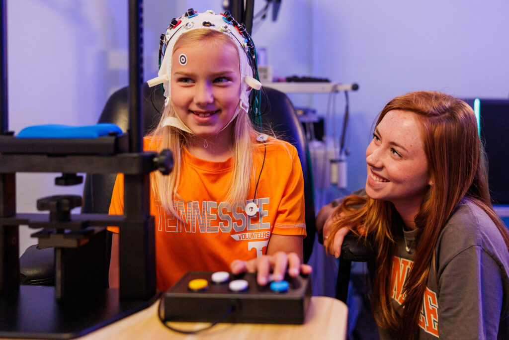 A student performs a cognitive brain scan on a child