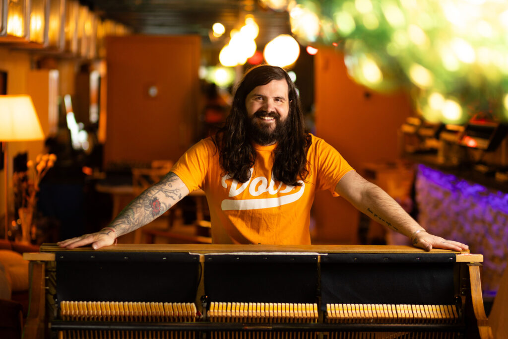 Kevin Rumely stands behind an organ